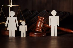 Litigation in Family Law. Dad And Mom With Child Figures With Judge Gavel ,Divorce.